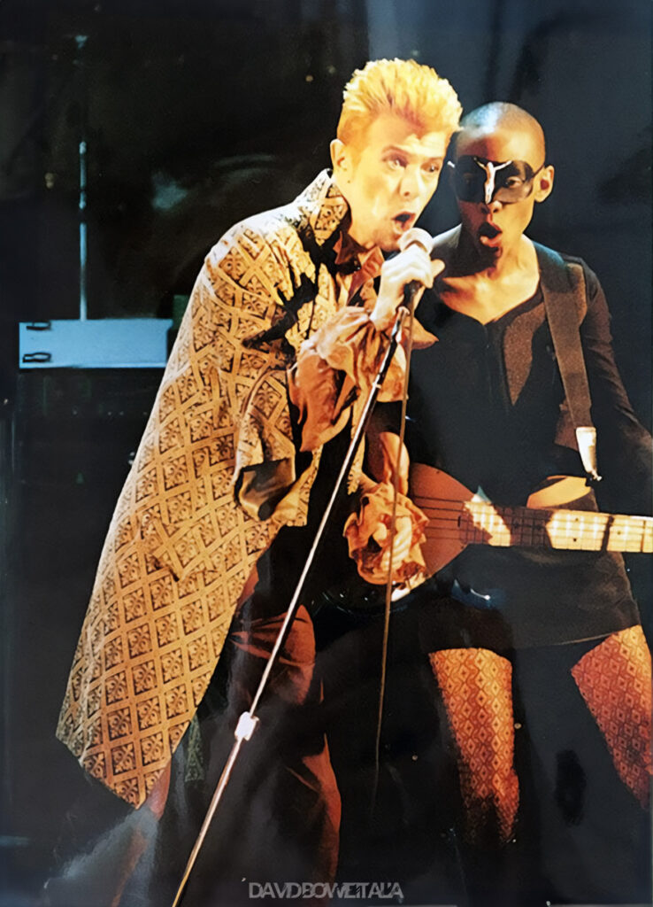 David Bowie a Sanremo | 20 Febbraio 1997 2 David Bowie canta accanto a Gail Ann Dorsey, con la mascherina nera, sul palco di Sanremo
